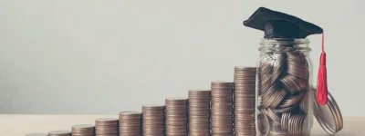 Image of coins arranged in a row, with a jar full of coins at the end of the row, topped with a mortarboard