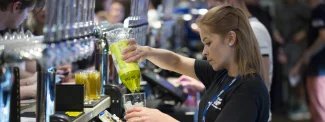 FiveSixEight bar staff pouring Lime and Soda into a glass at the bar