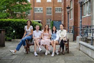 Group photo of 2023/24 Officer Trustees, sitting on a bench in Beit Quad