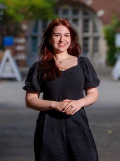 Headshot of Emina in Beit Quad, she is wearing a long black dress